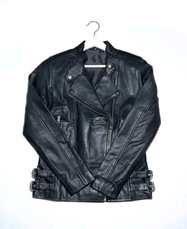 This premium leather jacket has a slim, and feminine fit. It’s cut from naked leather made in India that’s been hand selected for a luxurious look and feel. This jacket has an asymmetric closure and exposed hardware. 