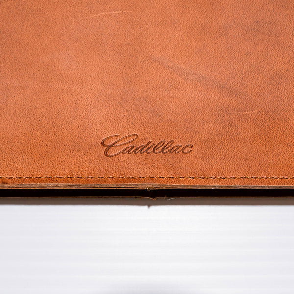 This laptop sleeve made of premium Buffalo leather acts as a document holder while holding up to a 14.5" laptop.